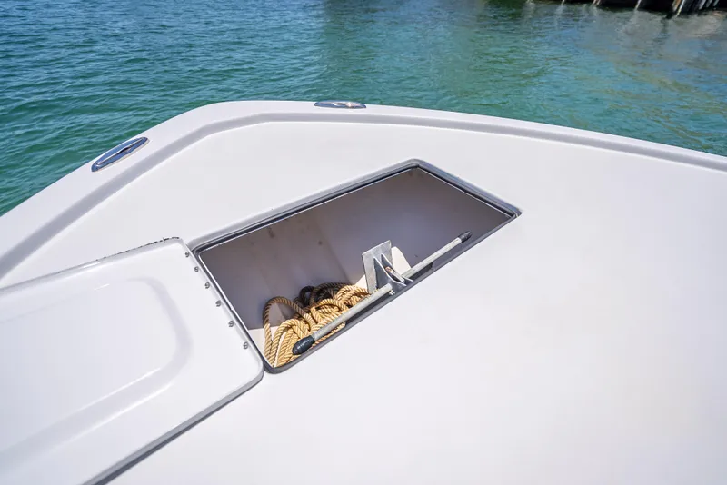 Slide: The Image of Open anchor compartment on 2011 Revenge 35LT boat with rope inside. - 13