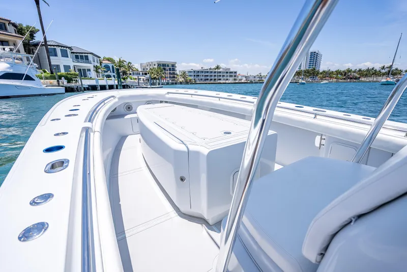 Slide: The Image of 2011 Revenge 35LT boat on water, sleek design, sunny day, waterfront homes in background. - 15