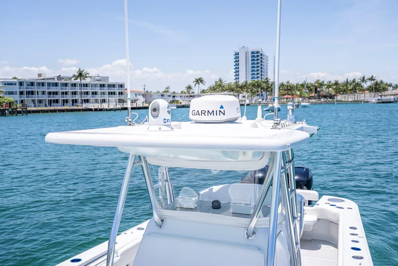 Slide: The Image of 2011 Revenge 35LT boat with Garmin equipment on a sunny waterfront. - 17