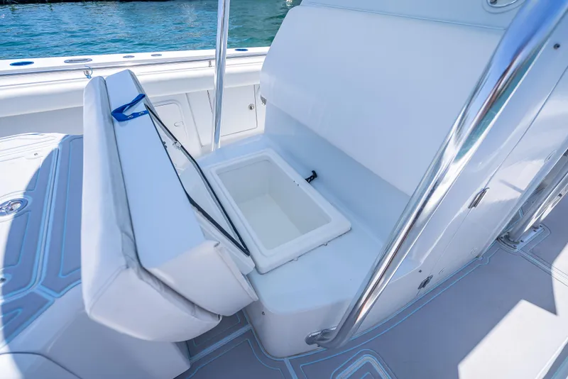 Slide: The Image of Luxury seating with storage on 2011 Revenge 35LT boat, featuring sleek design and ocean backdrop. - 18