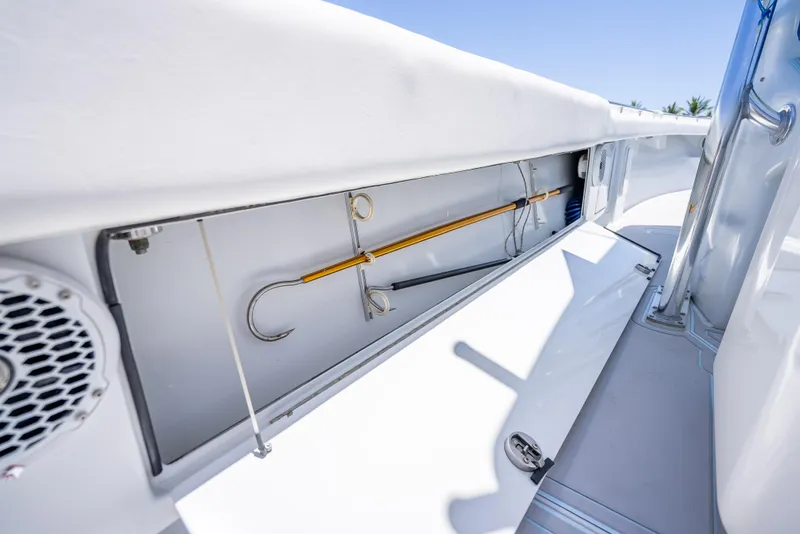Slide: The Image of Storage compartment on a 2011 Revenge 35LT boat, featuring fishing equipment and sleek design. - 19