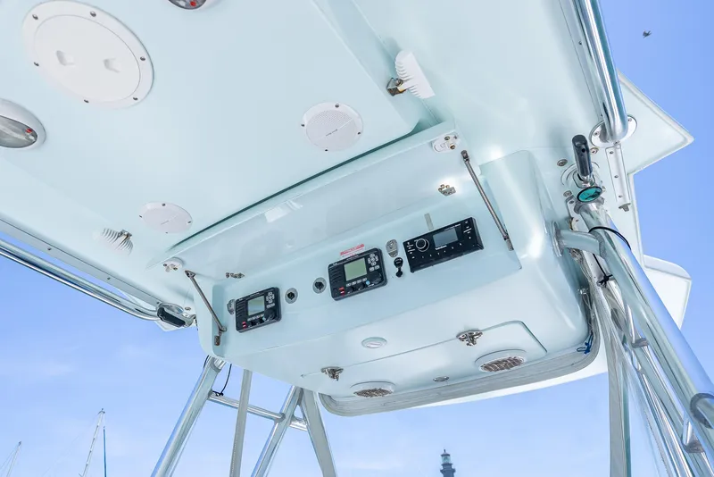 Slide: The Image of 2011 Revenge 35LT boat console with electronic controls and speakers, viewed from below. - 23