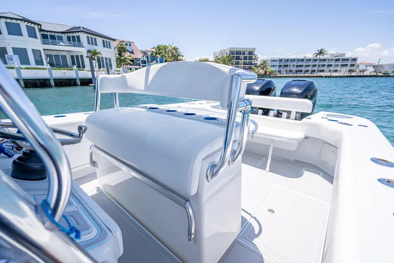 Slide: The Image of Luxury 2011 Revenge 35LT boat interior with white seating, docked near waterfront homes. - 24