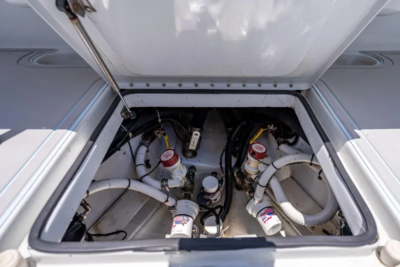 Slide: The Image of Open engine compartment of 2011 Revenge 35LT boat, showing mechanical components and hoses. - 28