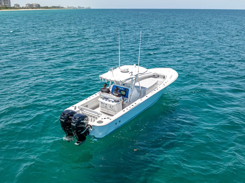 Slide: The Image of 2011 Revenge 35LT boat on open ocean, featuring dual outboard motors. - 6