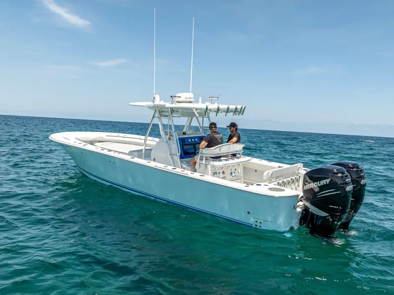 Slide: The Image of 2011 Revenge 35LT boat on open sea with two people onboard. - 7