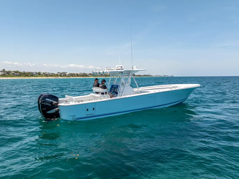 Slide: The Image of 2011 Revenge 35LT boat cruising on clear blue ocean waters. - 8