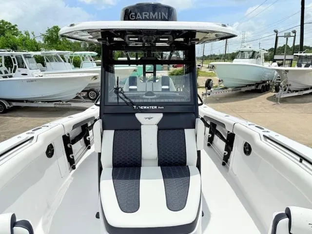 Slide: The Image of 2026 Tidewater 302 CC Adventure boat with Garmin equipment, featuring sleek seating and modern design. - 11