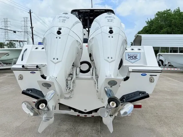 Slide: The Image of 2026 Tidewater 302 CC Adventure boat with dual outboard engines, rear view. - 3