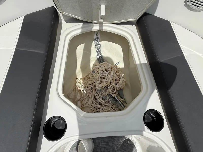 Slide: The Image of Anchor storage compartment on 2021 Bayliner VR5 boat, featuring rope and chain. - 10