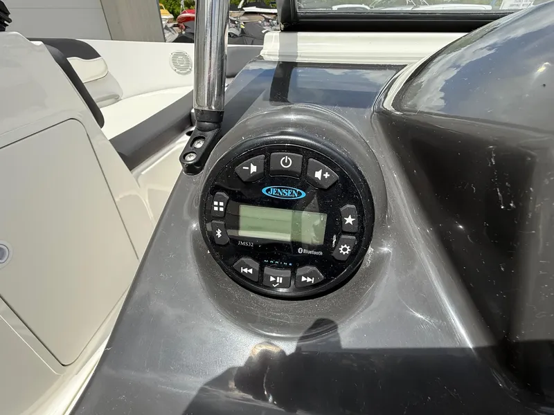 Slide: The Image of Jensen audio system on 2021 Bayliner VR5 boat dashboard, featuring Bluetooth connectivity. - 13