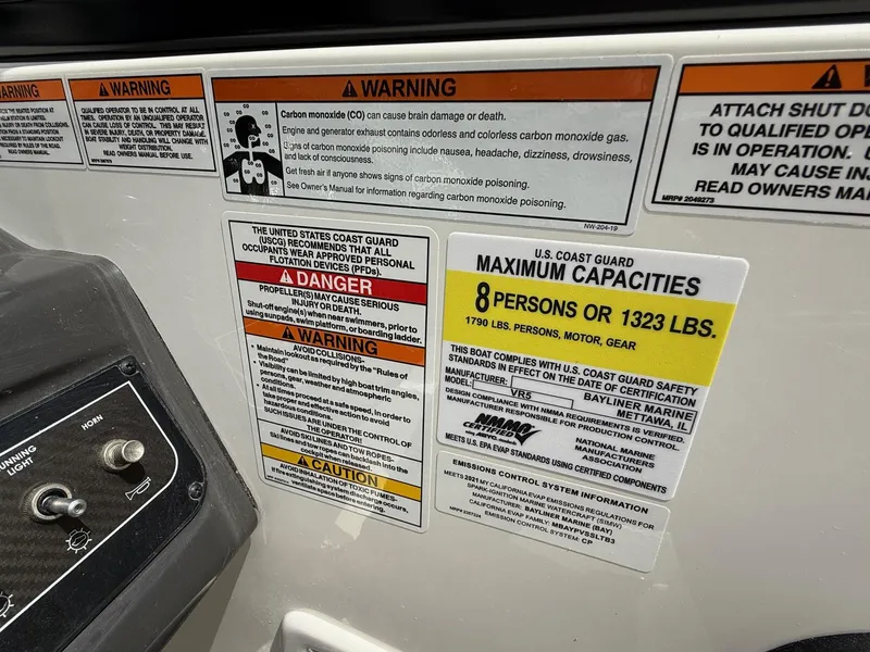 Slide: The Image of Bayliner VR5 2021 boat warning labels and capacity information, maximum 8 persons or 1323 lbs. - 14