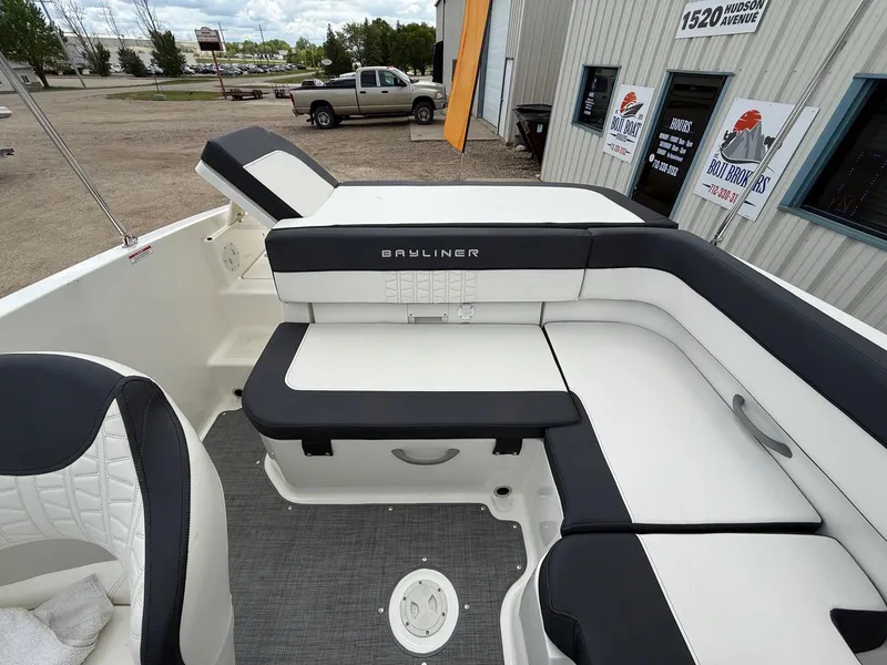 Slide: The Image of 2021 Bayliner VR5 boat interior with cushioned seating and modern design. - 20