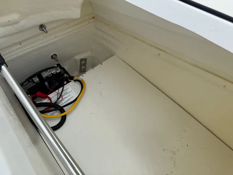 Slide: The Image of 2021 Bayliner VR5 boat battery compartment with wiring and connections. - 24