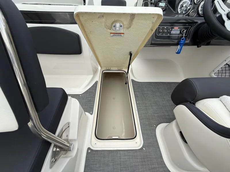 Slide: The Image of 2021 Bayliner VR5 boat interior with open storage compartment and seating. - 25