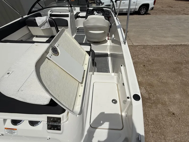 Slide: The Image of 2021 Bayliner VR5 boat interior with open storage compartment and seating area. - 8