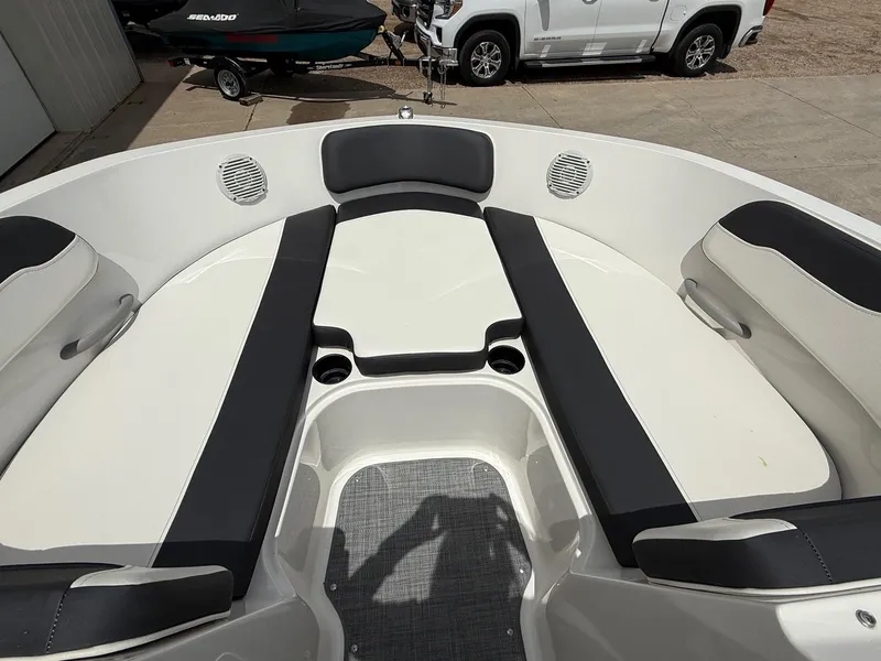 Slide: The Image of 2021 Bayliner VR5 boat interior with cushioned seating and cup holders. - 9