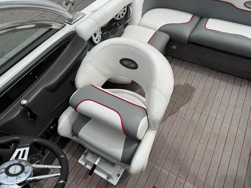 Slide: The Image of 2007 Supra Launch 20 SSV interior with gray and white seating, red accents, and striped flooring. - 8