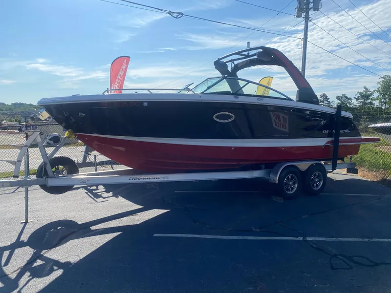 Slide: The Image of 2021 Chaparral 287 SSX boat on trailer, black and red design, parked outdoors. - 2