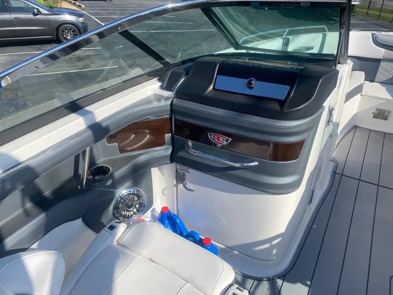 Slide: The Image of 2021 Chaparral 287 SSX boat interior with sleek dashboard and seating. - 5