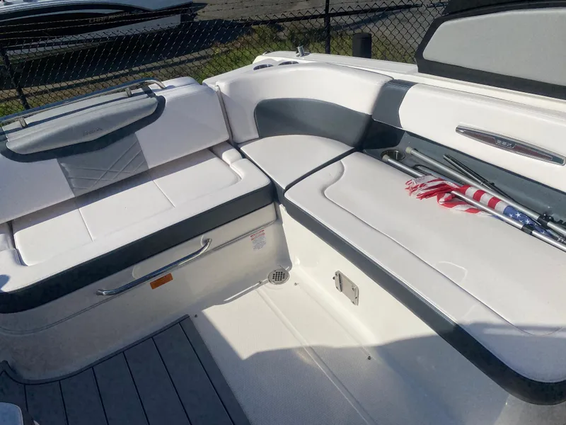 Slide: The Image of 2021 Chaparral 287 SSX boat interior with white seating and American flag detail. - 7