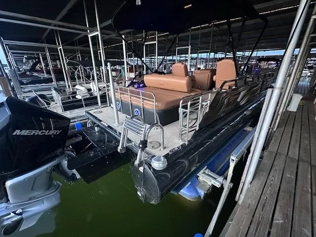 Slide: The Image of 2022 Regency 250 LE3 Sport pontoon boat docked with Mercury outboard motor. - 10