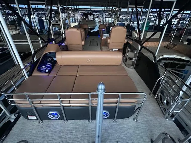 Slide: The Image of 2022 Regency 250 LE3 Sport pontoon boat with luxurious seating and modern design in a marina. - 11