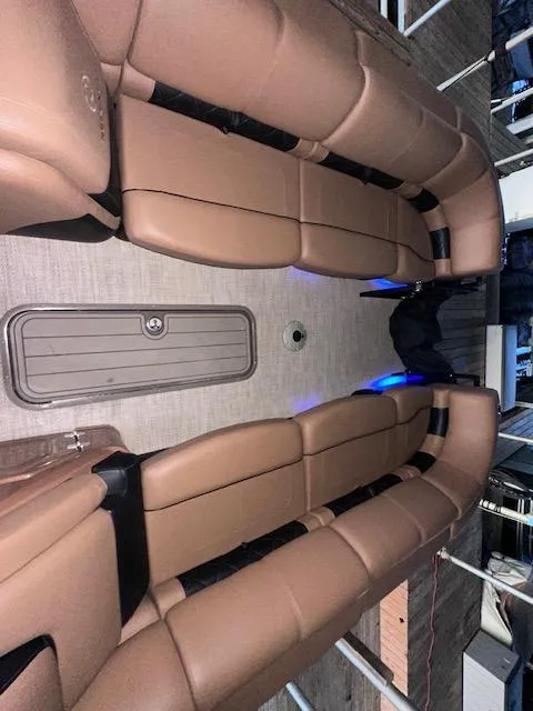 Slide: The Image of 2022 Regency 250 LE3 Sport interior with tan seating and ambient lighting. - 16