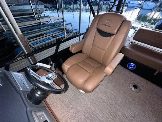 Slide: The Image of Captain's chair and steering wheel on 2022 Regency 250 LE3 Sport boat. - 18