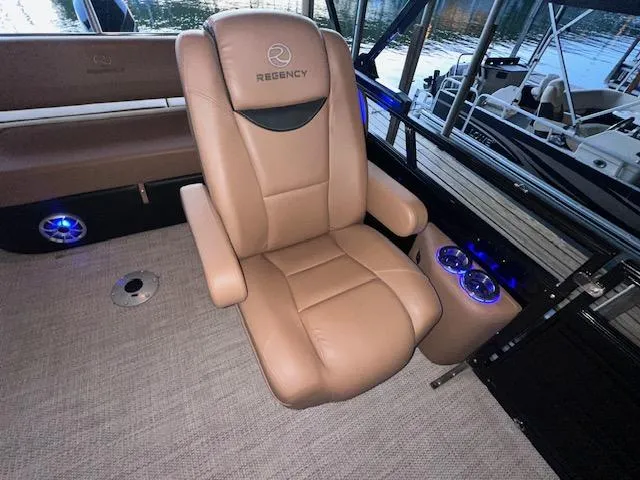 Slide: The Image of Luxurious seating on 2022 Regency 250 LE3 Sport boat with cup holders and ambient lighting. - 19