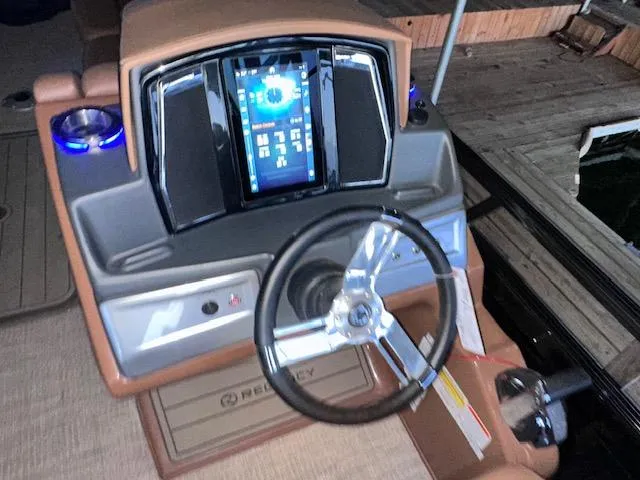 Slide: The Image of 2022 Regency 250 LE3 Sport dashboard with modern controls and steering wheel. - 20