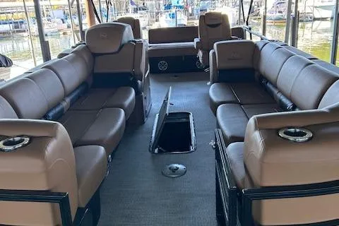Slide: The Image of 2022 Regency 250 LE3 Sport pontoon boat interior with luxurious seating and cup holders. - 3