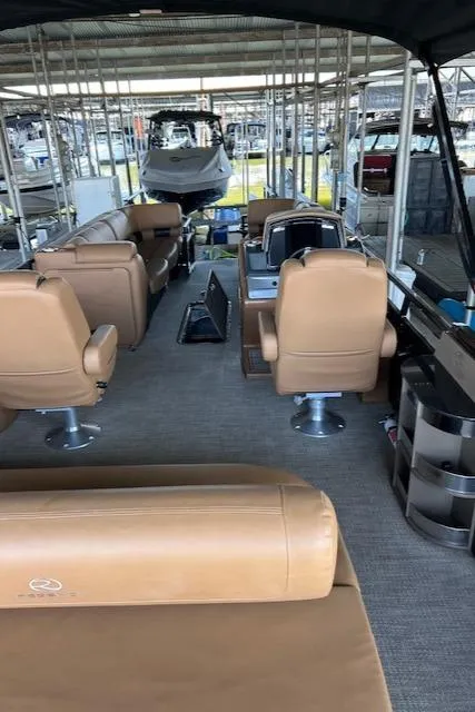 Slide: The Image of 2022 Regency 250 LE3 Sport boat interior with tan seating and spacious layout. - 4