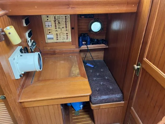 Slide: The Image of Navigation station inside 1983 Bluewater Vagabond 47 sailboat with wooden interior and equipment. - 15