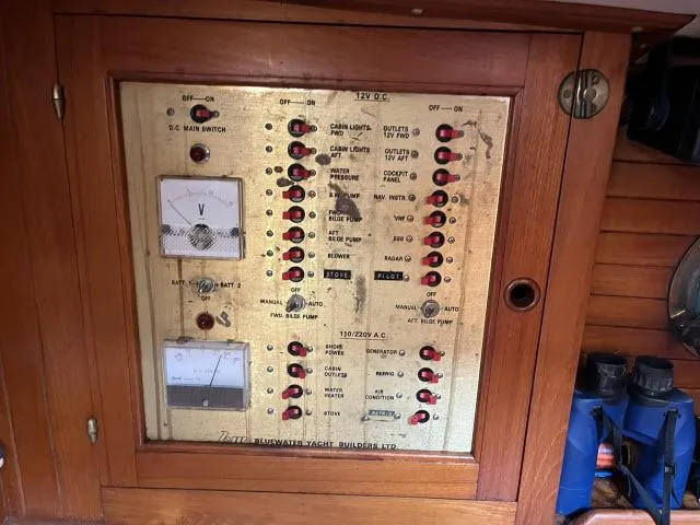 Slide: The Image of Electrical panel of 1983 Bluewater Vagabond 47 sailboat with switches and meters. - 18