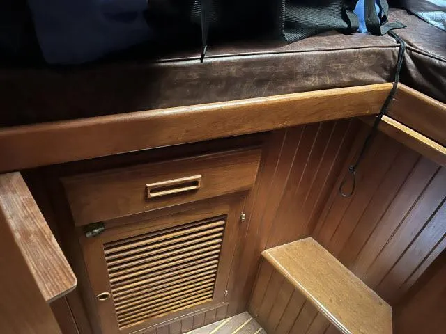 Slide: The Image of Interior of 1983 Bluewater Vagabond 47 sailboat with wooden cabinetry and seating. - 23