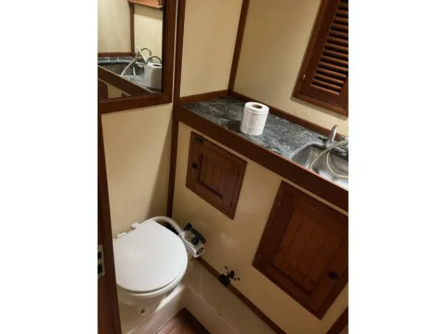 Slide: The Image of Bathroom interior of 1983 Bluewater Vagabond 47 yacht with toilet and sink. - 25