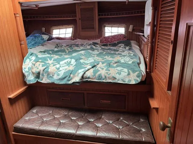 Slide: The Image of Cozy cabin interior of 1983 Bluewater Vagabond 47 sailboat with bed and storage. - 28