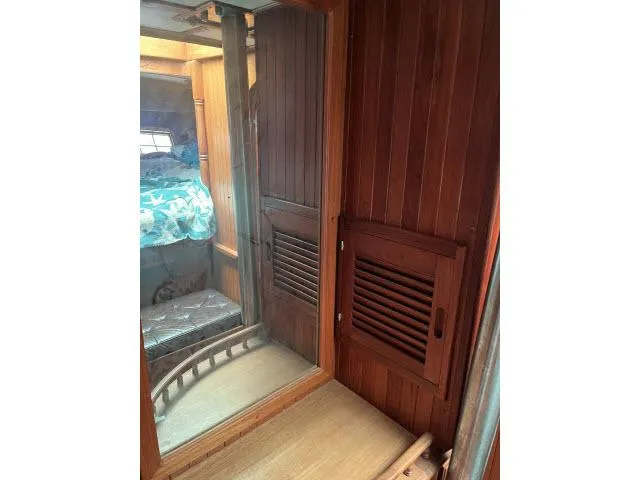 Slide: The Image of Interior of 1983 Bluewater Vagabond 47 sailboat with wooden paneling and cozy cabin. - 29