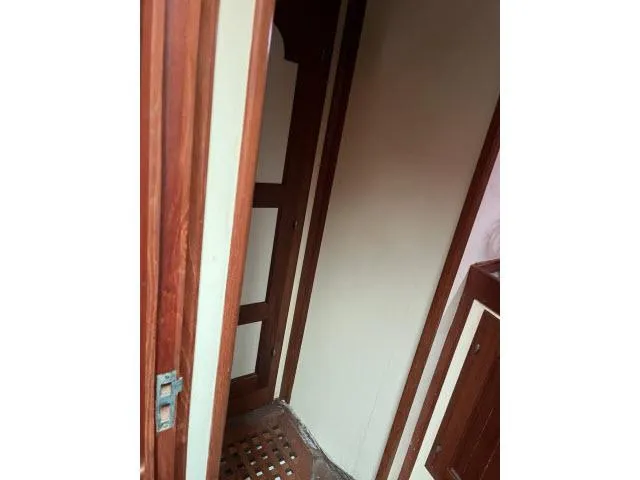 Slide: The Image of Interior view of 1983 Bluewater Vagabond 47 sailboat, featuring wooden door and paneling. - 31