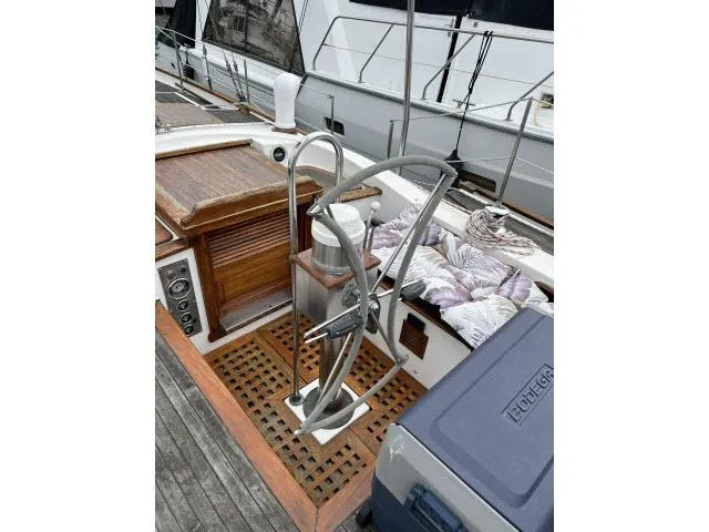 Slide: The Image of 1983 Bluewater Vagabond 47 sailboat cockpit with wooden accents and steering wheel. - 32