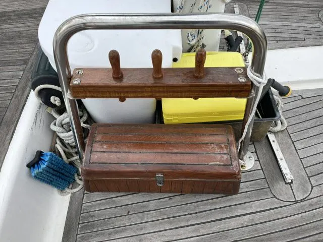 Slide: The Image of Wooden storage box and cleaning supplies on 1983 Bluewater Vagabond 47 sailboat deck. - 37