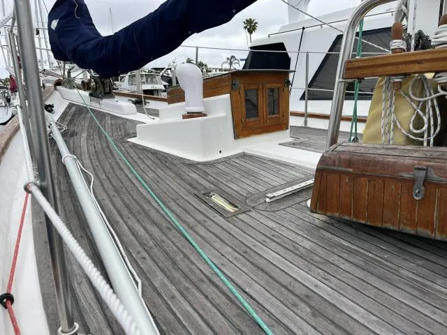 Slide: The Image of 1983 Bluewater Vagabond 47 sailboat deck with wooden details and rigging. - 38