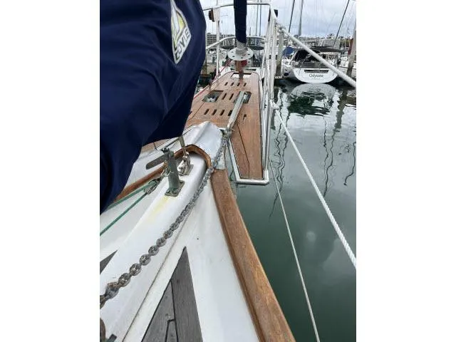 Slide: The Image of 1983 Bluewater Vagabond 47 sailboat deck with wooden details in a marina. - 39