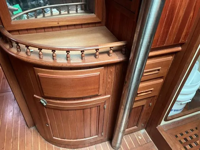 Slide: The Image of Wooden interior of 1983 Bluewater Vagabond 47 yacht with cabinets and drawers. - 4