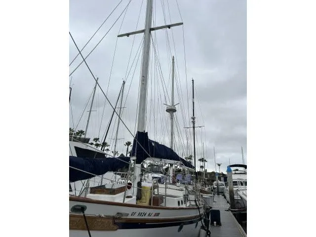 Slide: The Image of 1983 Bluewater Vagabond 47 sailboat docked at marina under cloudy sky. - 45