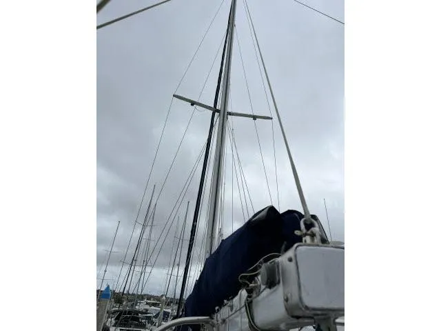Slide: The Image of Sailboat mast of 1983 Bluewater Vagabond 47 against cloudy sky. - 46
