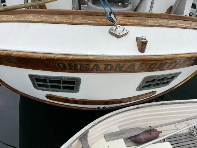 Slide: The Image of Stern of 1983 Bluewater Vagabond 47 sailboat named "Dreadnaught" docked at marina. - 47
