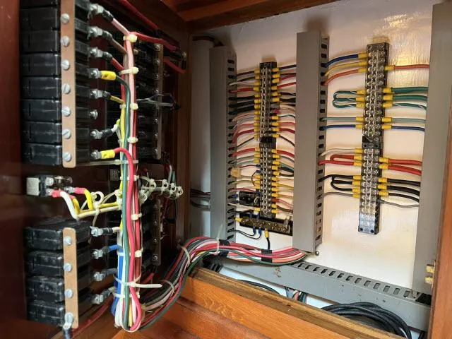 Slide: The Image of Electrical wiring panel inside a 1983 Bluewater Vagabond 47 sailboat. - 49