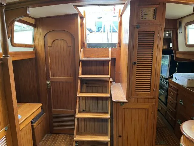 Slide: The Image of Interior of 1983 Bluewater Vagabond 47 sailboat with wooden stairs and cabinetry. - 5